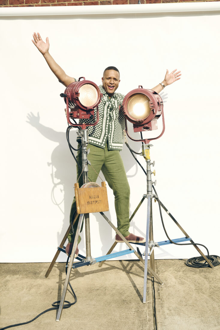 Craig Melvin stands on a set of lights