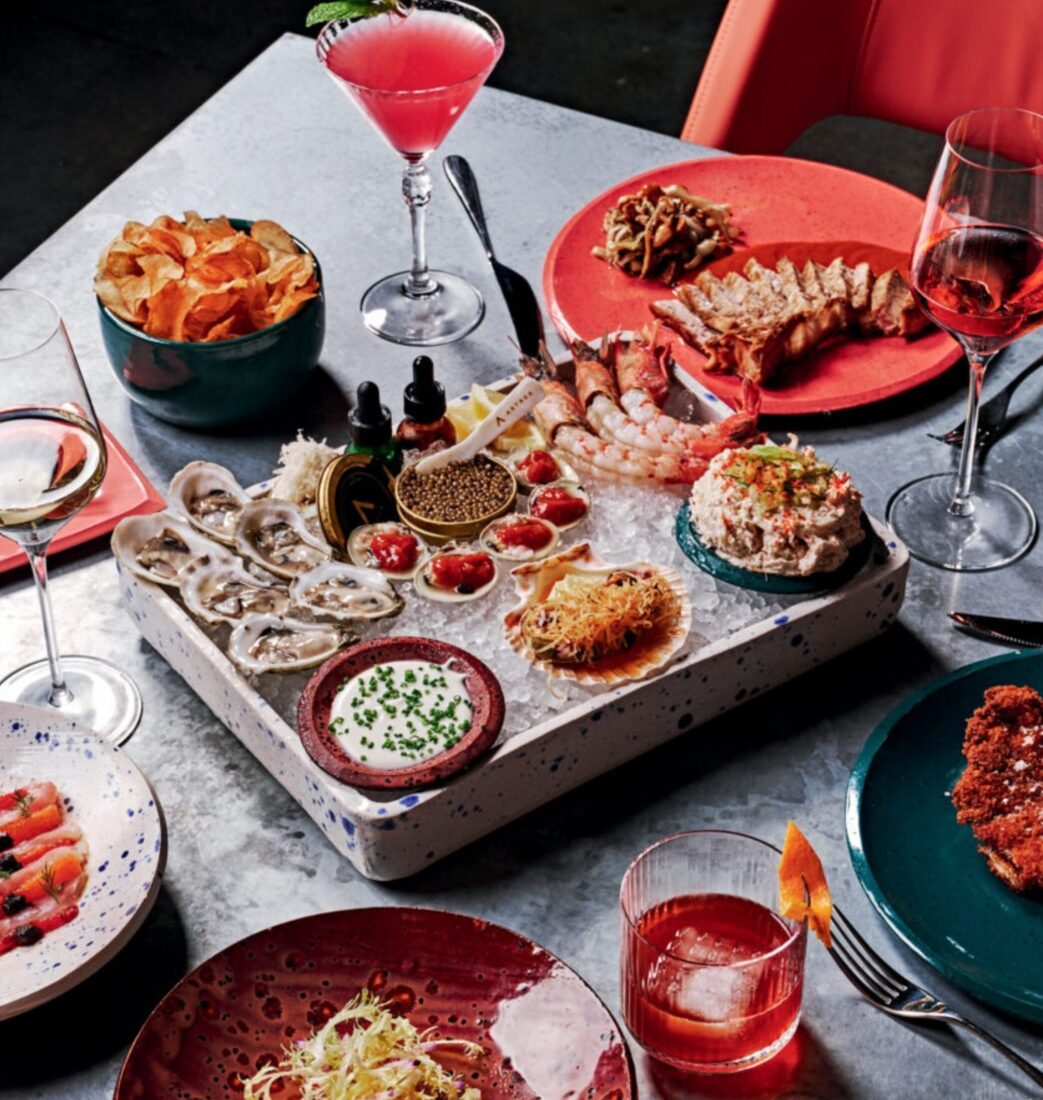 Gulf swordfish, cobia schnitzel, raw bar selections, and crudos on a table