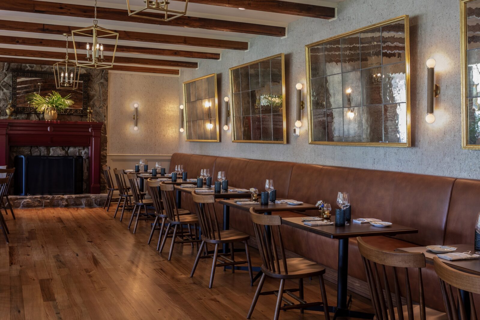 dining room banquette with mirrors on wall