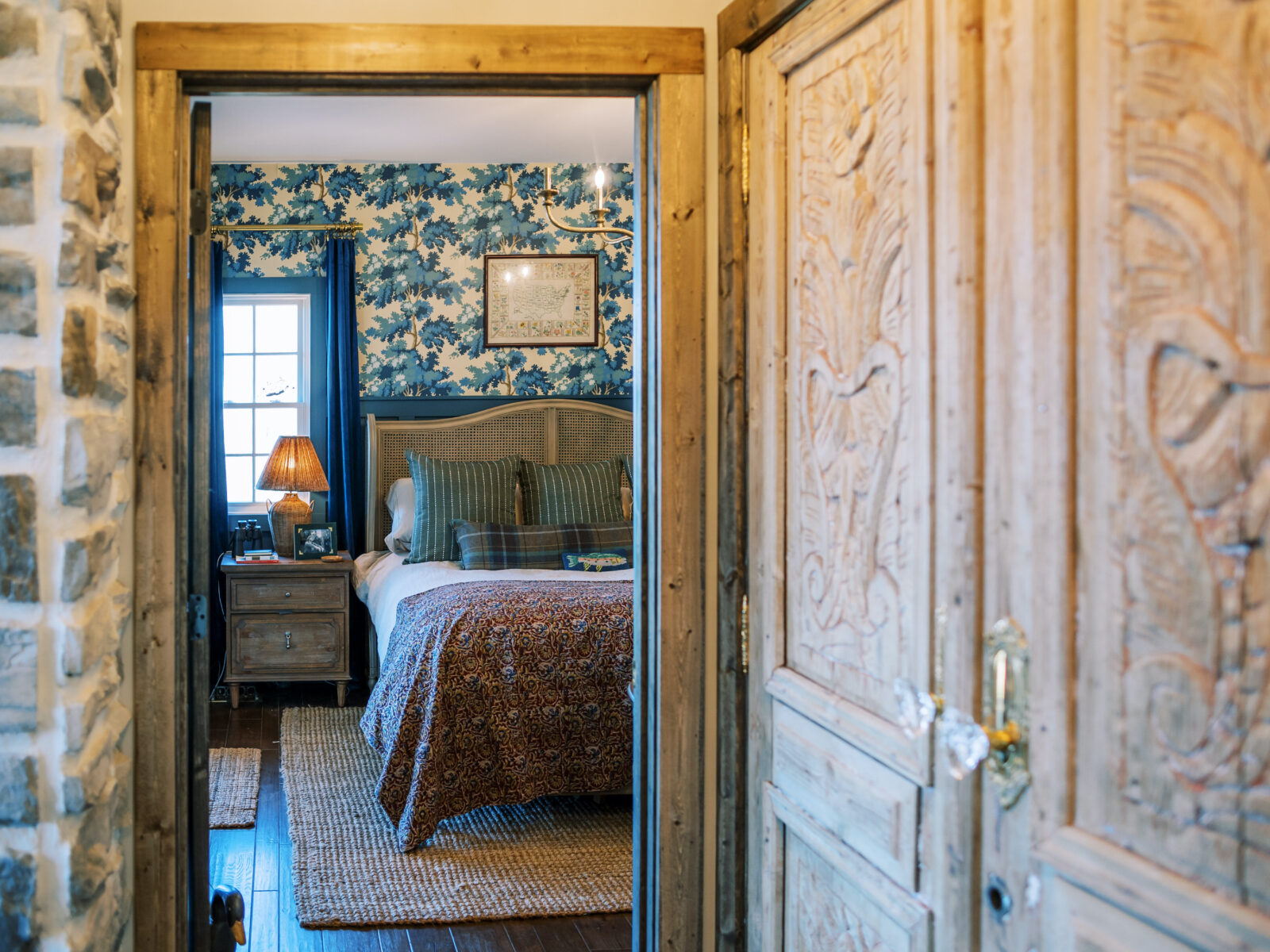 A bedroom with floral wallpaper