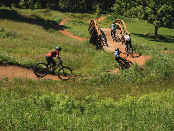People bike on a trail outdoors