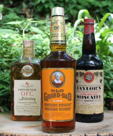 Bottles of bourbon on display a stump