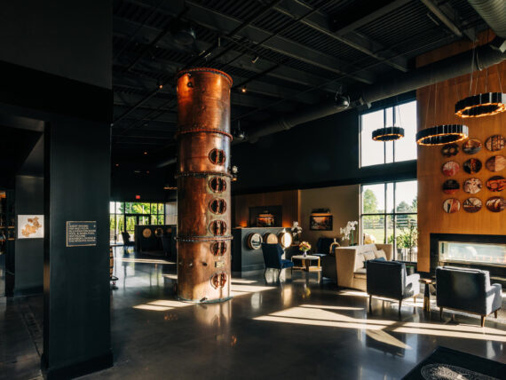 A hotel lobby with a polished interior and copper still