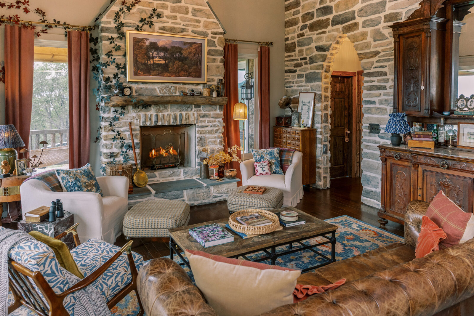 A cozy living room with a stone fireplace